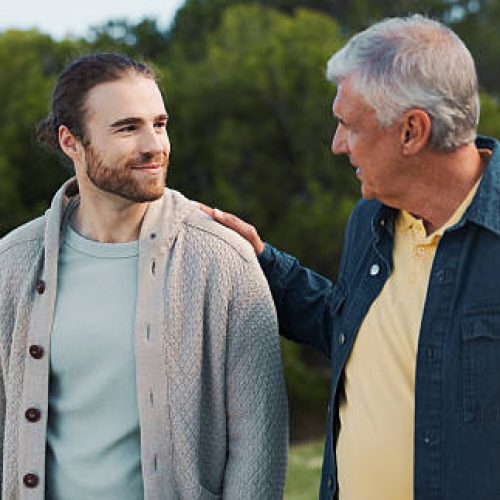 Father, son and walk with comfort at park for family reunion, bonding together and summer vacation. Smile, senior dad and men with discussion, support and travel journey with parent advice in nature